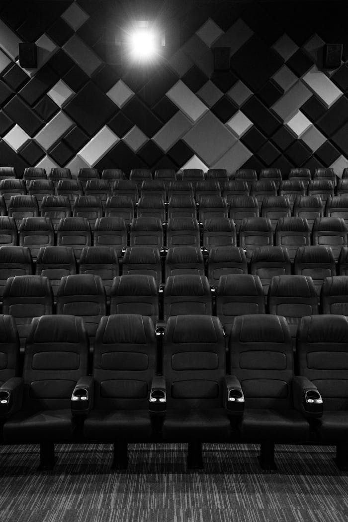 Grayscale Photo of Empty Seats in Movie Theater